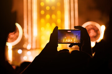 Taking photo or video content for social networks at the concert, Mobile phone on music show.