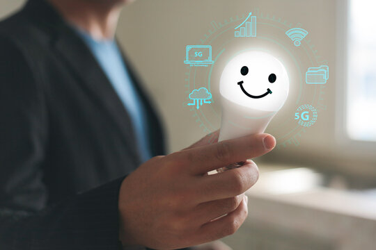 Digital innovation. Business man Hand holding smile light bulb, innovation technology, business icons on network connection