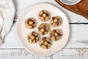 Hazelnut cookies. Chocolate and hazelnut cookies on a white wooden background. patisserie products. Top view