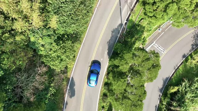 Showing the sports car driving on the road and highway in above aerial view