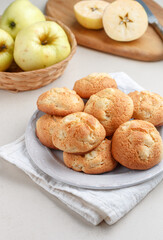 Freshly baked homemade soft apple cookies on a white plate on a marble table