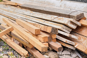Many wooden boards and beams at construction site, closeup detail