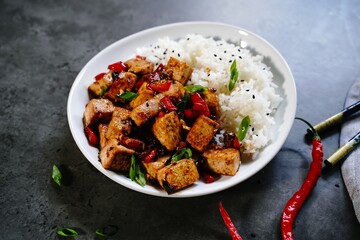  Szechuan tofu stir fry served with jasmin rice, selective focus