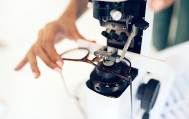 Lens, glasses or hand with tool for eye care, vision and focus with closeup at optometrist or optometry. Eye care, ophthalmology and healthcare for medical support, eyewear or spectacles to see