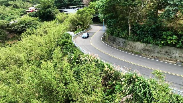 Showing the sports car driving on the road and highway in surround aerial view