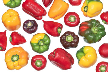 Whole different colored sweet peppers isolated on white background