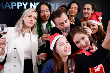 Group of men, young woman smiling, happy celebrating Christmas, drinking champagne, partying.