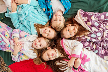 Group of children having fun at pajama party. Cozy home. Top view