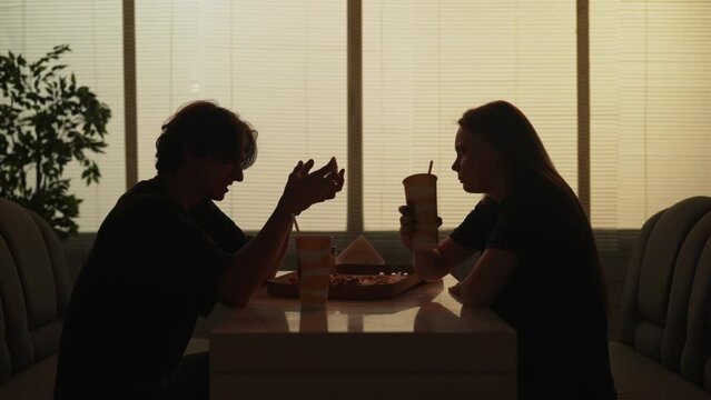 Man and woman sitting at the fast food bistro bar arguing, angry talking, girl shouting and walks away.