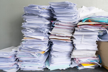 A stack of used papers or old documents was well packed and kept outside office, waiting for rubbish management
