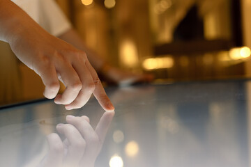 Woman using interactive touchscreen display of electronic multimedia kiosk,  Education, learning...