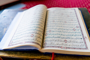 Fototapeta premium An open holy quran with provisions of the Muslim religion to improve prayer lies in mosque