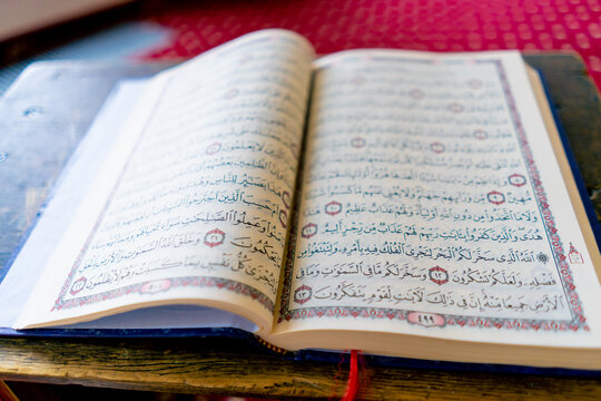 An open holy quran with provisions of the Muslim religion to improve prayer lies in mosque