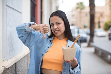 hispanic pretty woman with an asian noodles bowl