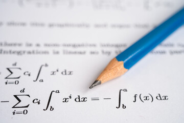 Pencil on mathematic formula exercise test paper in education school.