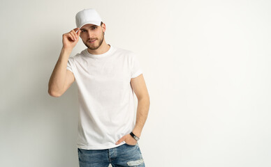 Handsome man wearing blank white cap and white t-shirt isolated on white background.