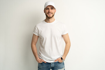 Handsome man wearing blank white cap and white t-shirt isolated on white background.