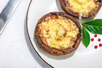 Baked portobello mushrooms with cheese and spices. Healthy vegan food ready to eat