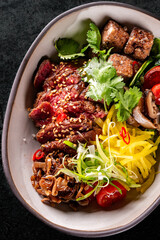 Donburi bowl with beef meat and vegetables on table