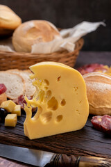 chopping board of cheeses and salami cold cuts of various varieties homemade country bread with almonds and handmade knife