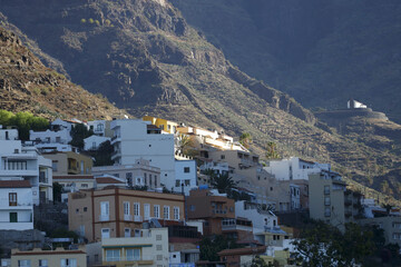 Fototapeta na wymiar La Gomera, Spain. Onshore view of the coastline of Valle Gran Rey with the small town of La Calera.