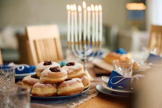 Traditional Jewish jam filled donuts on dining table.