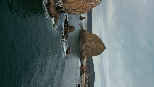 Vertical wide Aerial shot of Haystack Rock beach in coastal town Cannon Beach, Oregon