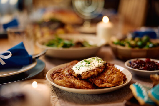 Potato latkes, traditional Jewish food on dining table during Hanukkah.