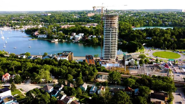 approaching a high-rise being built in Halifax, Nova Scotia. Top building under construction by the water, on a beautiful summer afternoon.