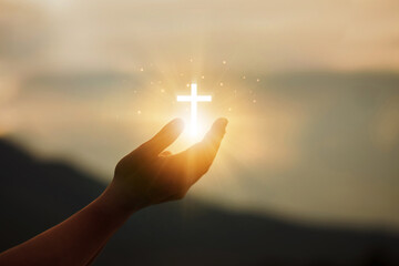 Human hands open palms up to worship hope with the Cross is a symbol of Christianity.Concept...
