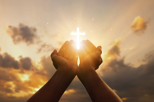 Human hands open palms up to worship hope with the Cross is a symbol of Christianity.Concept Religion and spirituality with believe Power of hope or love and devotion. fighting and victory for god.