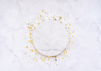 White marble cosmetic podium product design and Christmas golden stars confetti