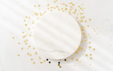 White marble cosmetic podium product design and Christmas golden stars confetti