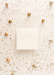 White blank paper square card mockup and golden various sizes stars confetti on white Christmas background