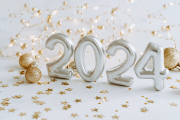 Greeting card - happy new year with numbers 2024, decoration lights and Christmas balls on white background