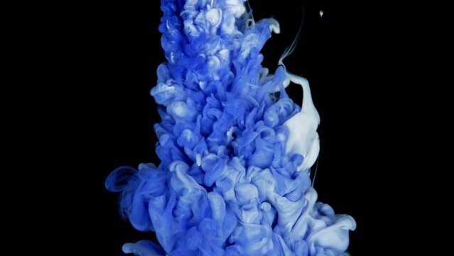 Colorful ink paint top view blending in the water in slow motion. Ink liquid underwater on black background. white blue abstraction