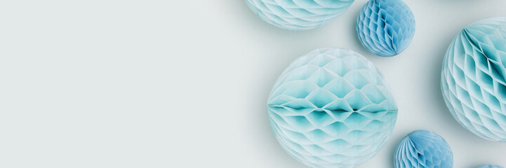 Banner with tissue paper balls different sizes on a blue background. Place for text.