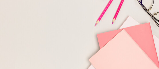 Banner with pink school supplies on a gray background. Place for text.