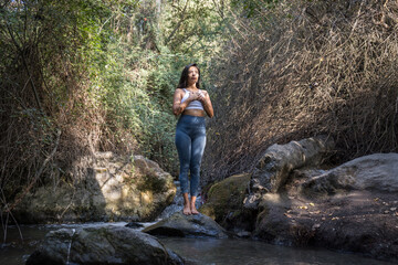 Woman doing yoga in the river