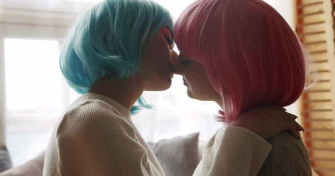 Embrace and holding each other. Love and kiss, Pride Event, friendship concept. Romance and portrait of lesbian couple with blue and pink hair enjoying. LGBT rights, Lesbian family.