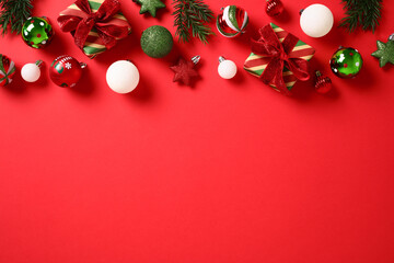 Red Christmas background with baubles and decorations.