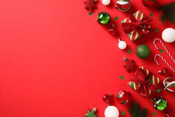 Christmas flat lay composition with gift boxes, baubles, decorations on red background. Flat lay,...