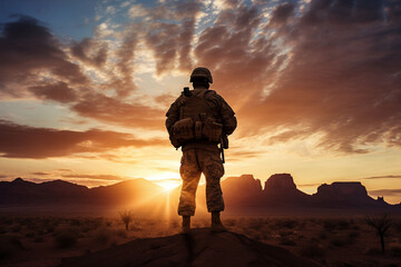 Against a breathtaking desert sunrise, a soldier in uniform stands in silhouette, the promise of a new day bringing hope and resolve to their military duties in the arid landscape.  - obrazy, fototapety, plakaty