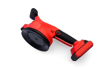 Red rechargeable vibrating vacuum suction cup for laying tiles isolated on a white background.