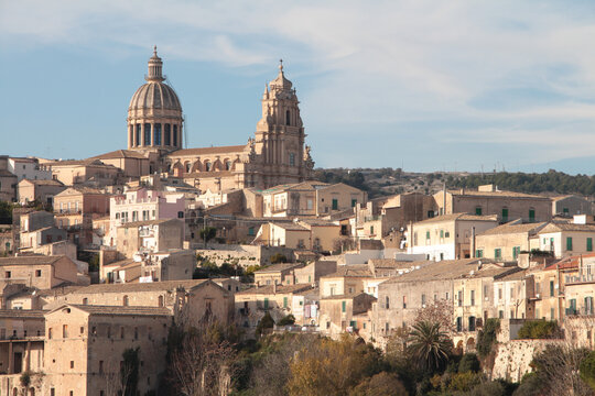 ragusa sicily italy town medium shot church buildings homes houses on hill unlevel uneven ground with sky above