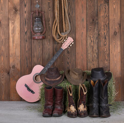 guitar and cowboy boots in the barn