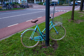 Locked bicycle to a pole in Rotterdam, Nederland.