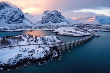 Obraz premium Aerial view of bridge over the sea and snowy mountain