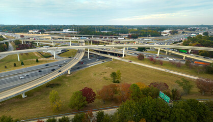 Aerial view of american freeway intersection with fast moving cars and trucks. USA transportation infrastructure concept