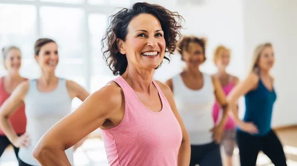 Papier Peint photo Lavable Fitness Group of mid aged ladies doing aerobics exercise in sport club, joyful women dancing with friends in work out studio, with copy space.